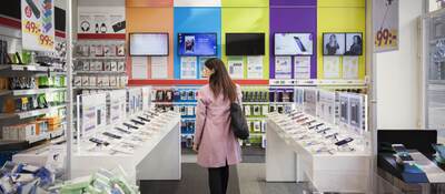 Woman browses products in an electronics store.