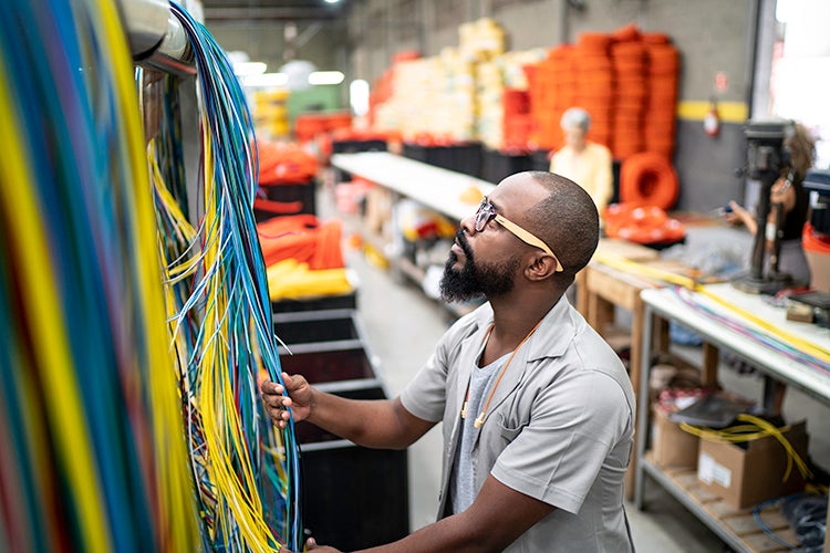 Person working with cables on a server rack