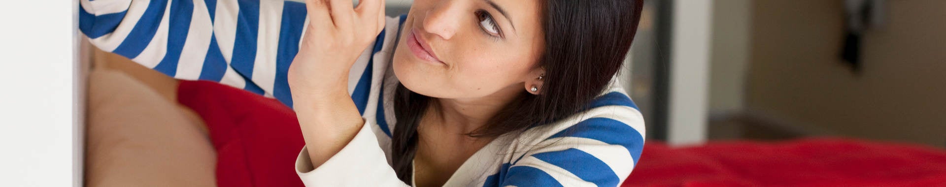 Woman changing light bulb to energy saving bulb