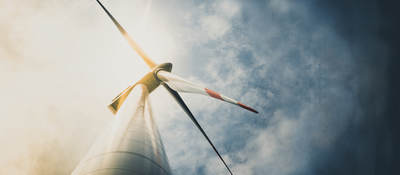 Looking up at a wind turbine