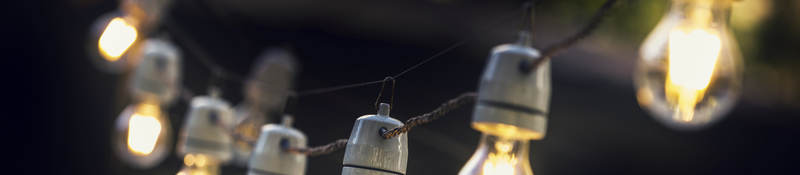 A strand of string lights in an outdoor setting. 