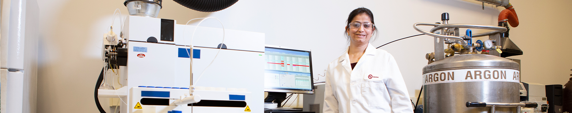 UL Solutions scientist standing next to a computer and a tank of argon